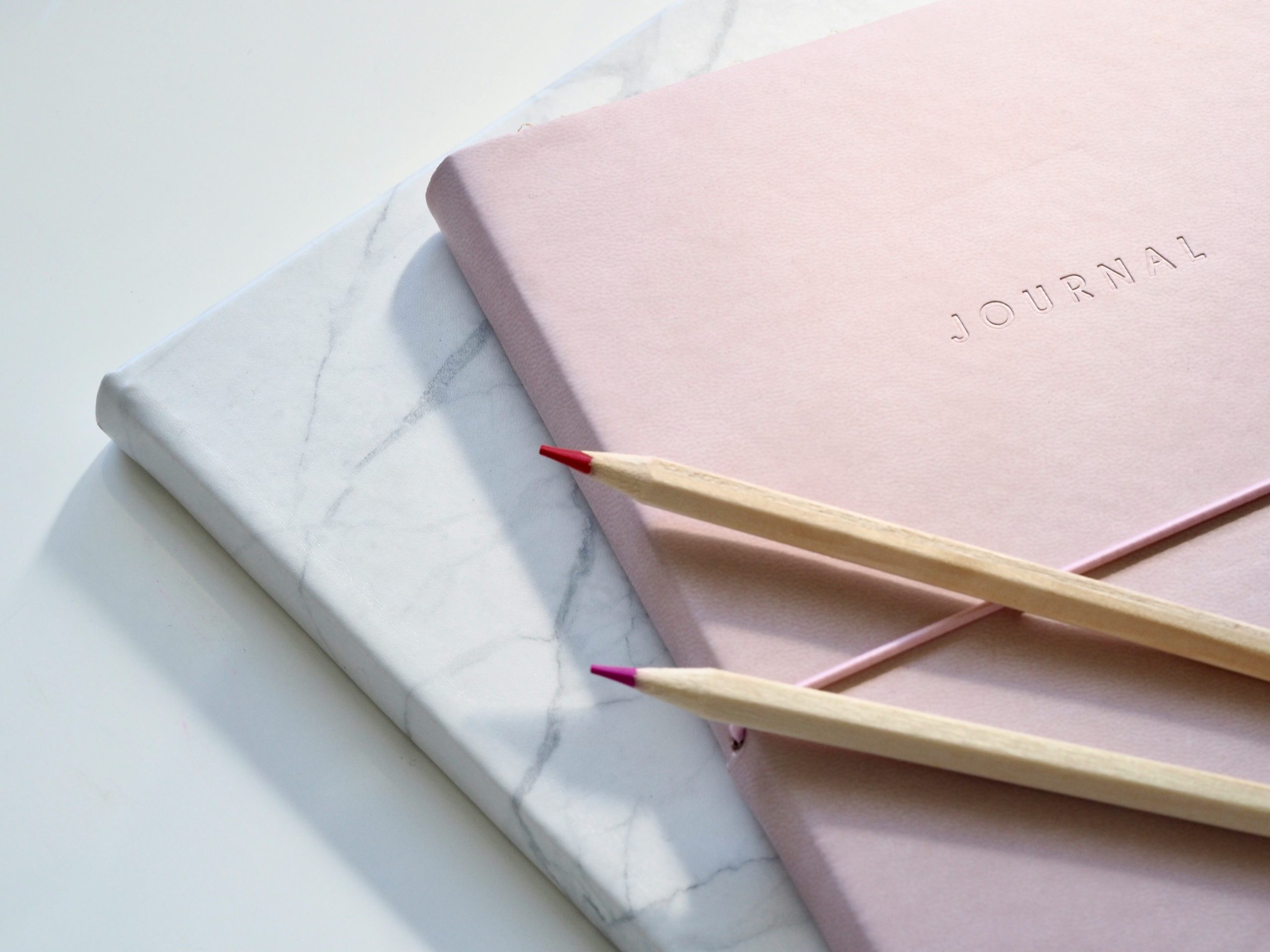 2 journals with coloured pencils